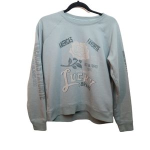 Lucky brand. Blue-gray crewneck with rose design and lettering down sleeves